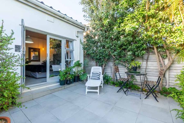 Private patio with garden chairs outside the Garden Room