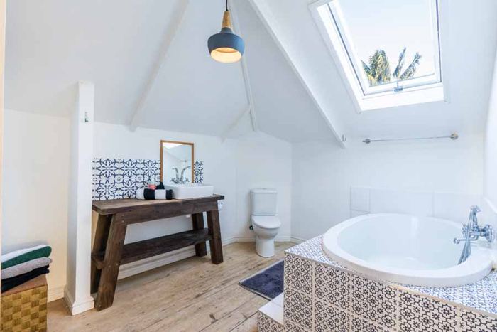 Bathroom with bath and patterned tiles in the Main Villa